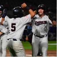 Elijah Dunham of the Somerset Patriots is greeted at home plate